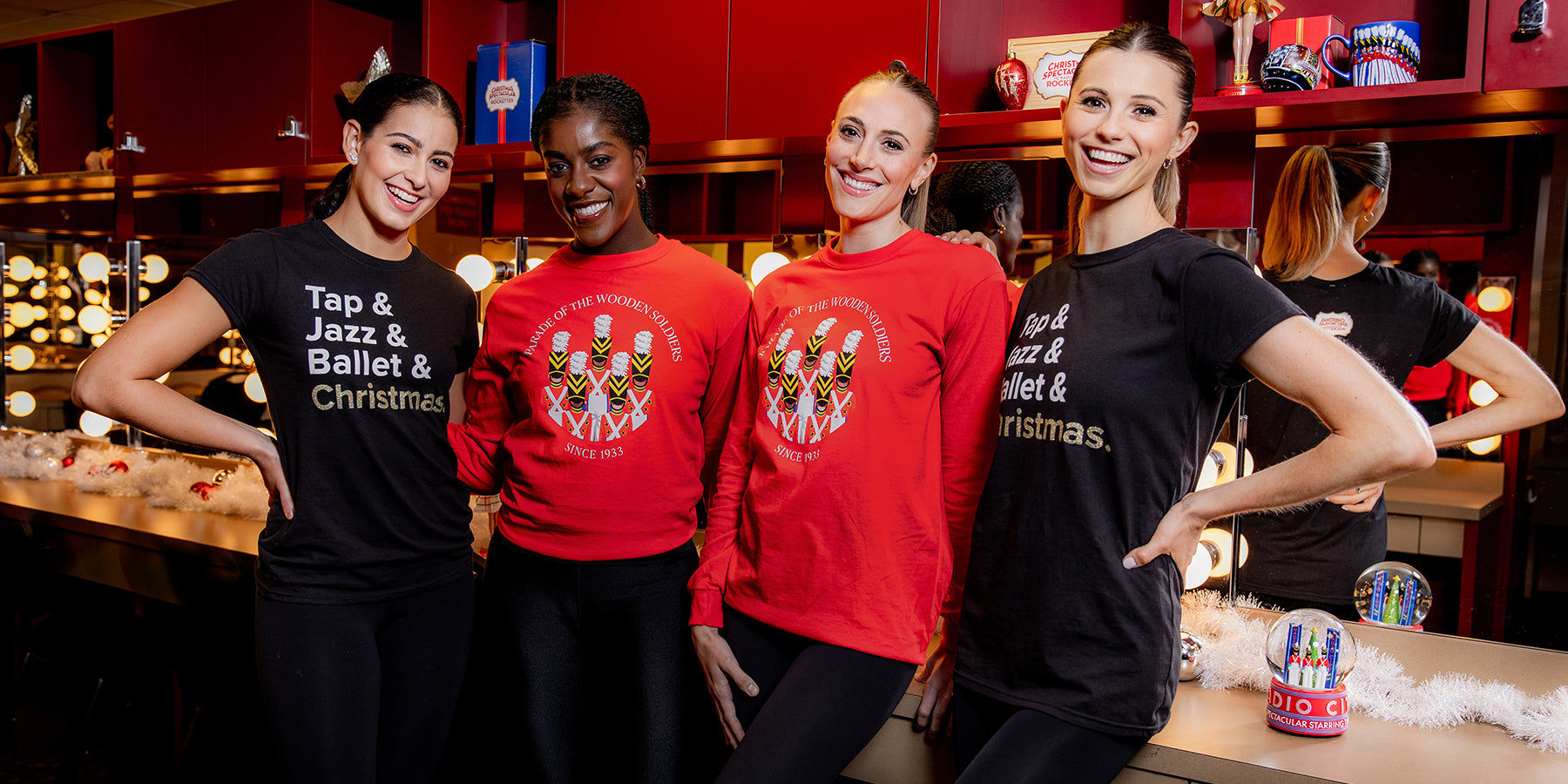 Four women wearing official merchandise from the Radio City Rockettes Christmas Spectacular performance